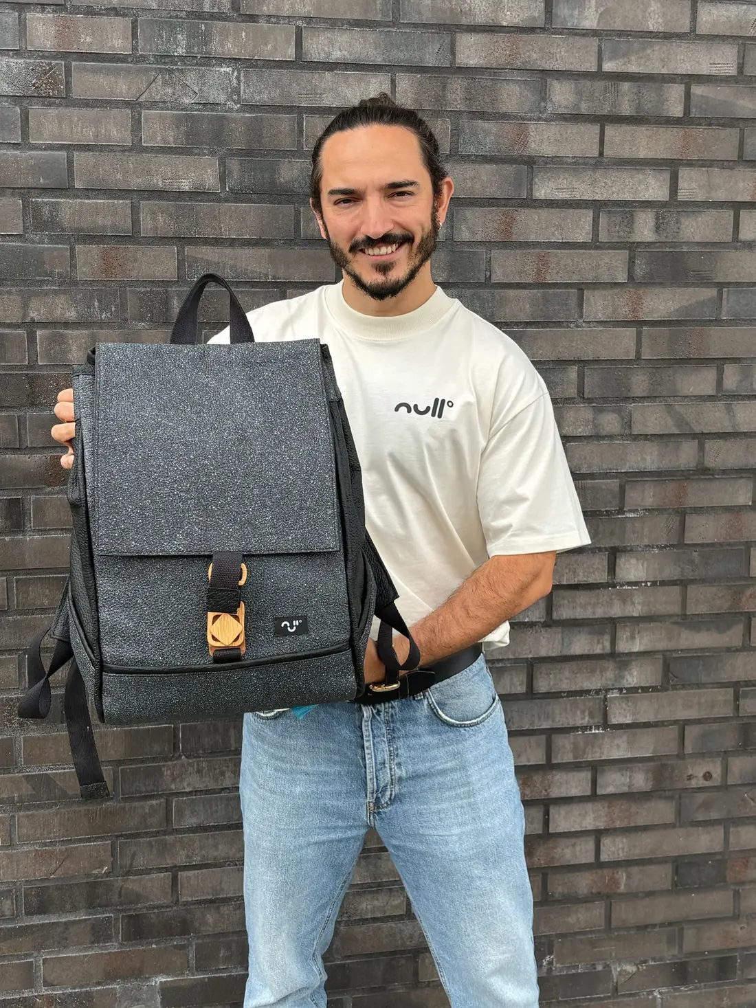 Pascal, founder of null°, holding backpack